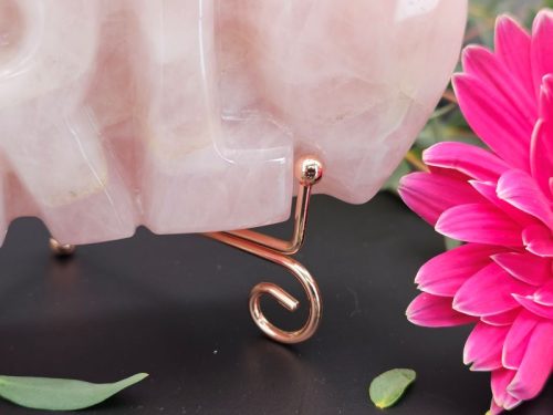 Close-up of rose-gold display stand supporting the crystal carving
