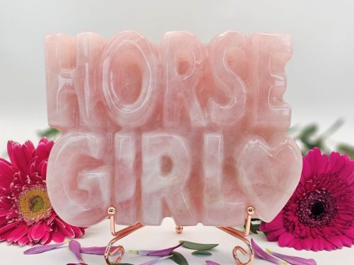 Horse Girl carving displayed on rose-gold stand against white background